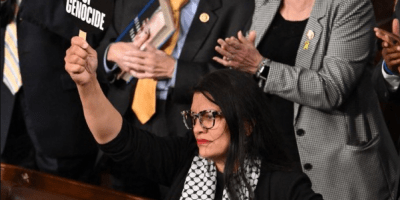 Rashida Tlaib holds a sign saying "guilty of genocide" during Netanyahu's speech.
